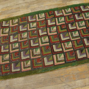 Textured runner with red, green, gray, and beige geometric patchwork squares on rustic wood flooring.