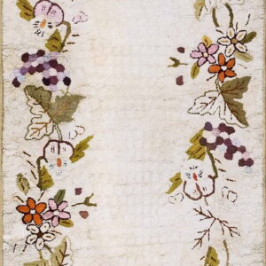 Cream textured runner bordered by winding vines, green leaves, pink flowers, and purple grape clusters.