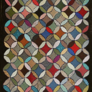 Textured, multicolored rug featuring a repeating geometric pattern of interlocking circles on a dark background.