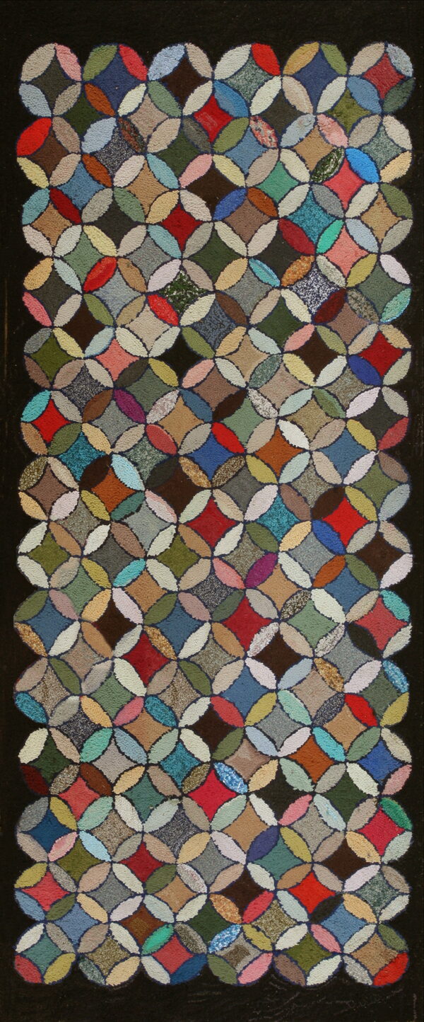 Textured, multicolored rug featuring a repeating geometric pattern of interlocking circles on a dark background.