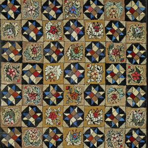 Multicolored hooked rug displaying a checkerboard of geometric star patterns and stylized earthy floral blocks.