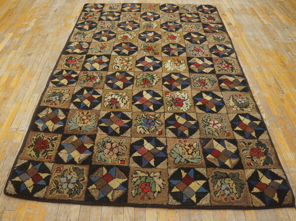 Rustic multi-colored rug featuring a checkerboard pattern of dark floral and geometric star squares on plank wood flooring.