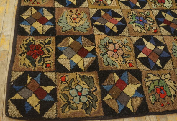 Textured, multicolored rug featuring a checkerboard pattern of floral and star motifs on light wood floors.