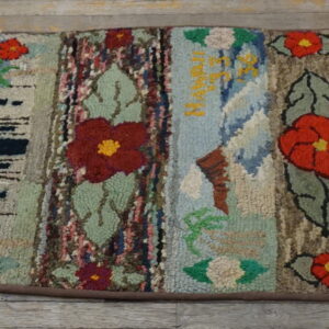 High-texture multi-colored runner featuring vertical patchwork panels of flowers, leaves, and written text on a wood floor.