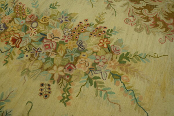 Pale yellow textured rug with a dense cluster of pink, green, blue, and purple flowers.