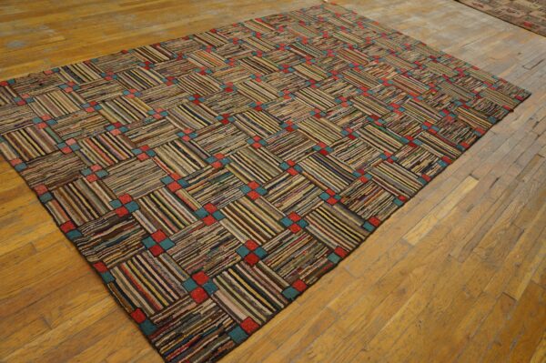 A chunky, multicolored strip rug features a basketweave pattern with intersecting red and teal squares on wood flooring.