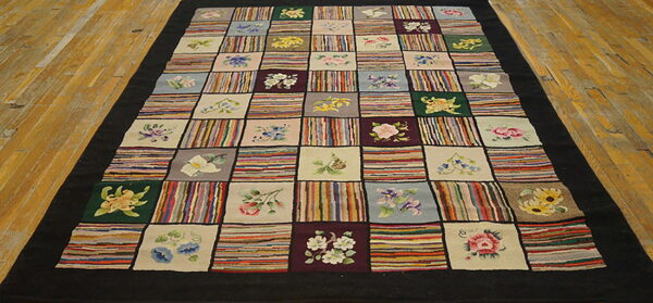 Multi-colored patchwork rug with alternating floral motifs and variegated striped squares on a wooden floor.