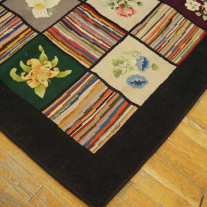 Detail of a hooked rug showing floral and multicolored striped squares bordered in black on a light wood floor.