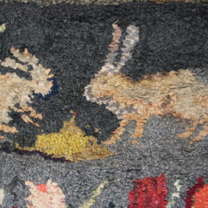 Highly textured, chunky looped rug with an abstract pattern in dark gray, tan, yellow, and red.