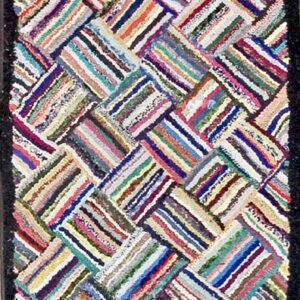 Multicolor runner rug with shaggy texture, a chevron pattern, and a solid dark border.