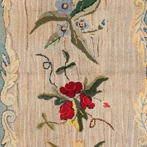 Narrow runner with red, yellow, and blue flowers and an elaborate aqua and gold scrolling leaf border.