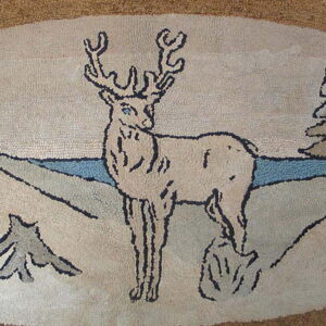 Detail of a hooked rug featuring a deer outlined in dark brown against a beige and blue landscape.
