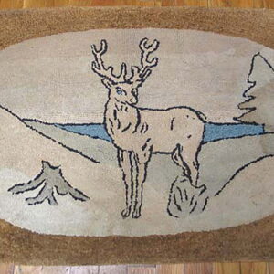 Rustic tan rug with a central cream oval depicting a deer, pine trees, and a blue stripe on wood floor.