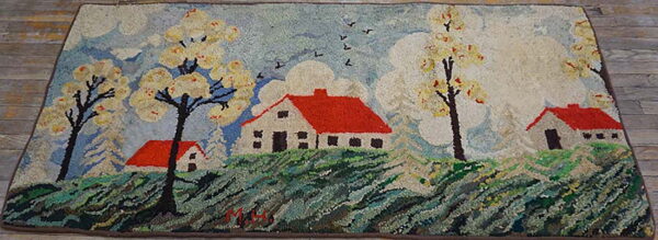 Textured pictorial rug showing red-roofed houses, green hills, and white trees under a blue sky.