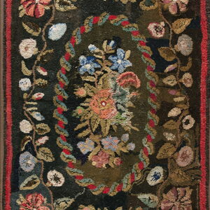 Dark antique floral rug with a chunky, hooked texture and a central oval medallion of flowers.