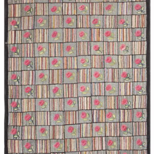 Multicolor rug featuring a dense checkerboard design of pink floral motifs and vertical stripes, framed by a dark border.