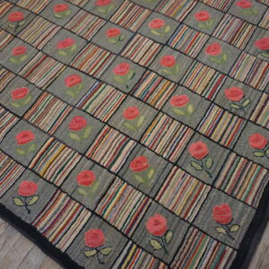Textured rug with a checkered pattern of gray roses and vertical multicolored stripes on wood flooring.