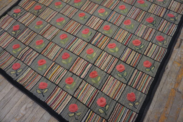Textured rug with a checkered pattern of gray roses and vertical multicolored stripes on wood flooring.