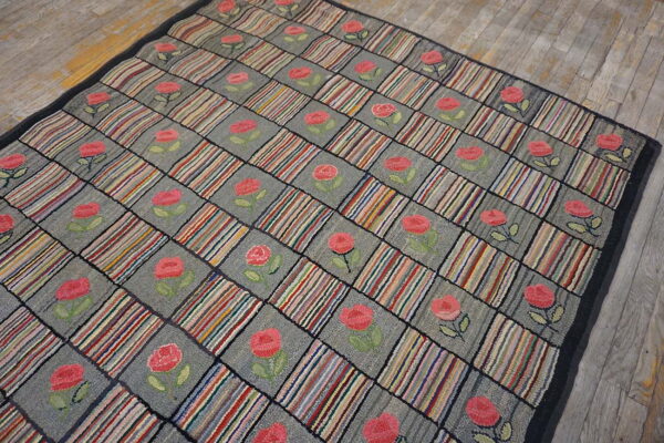 Hooked rug featuring a multicolored striped and rose checkerboard pattern on weathered wood floors.