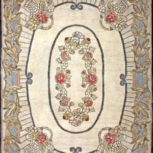 Ivory rug featuring a central oval of pink and white flowers surrounded by scrolling gold and blue borders.