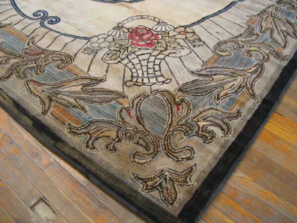 A textured rug corner featuring a beige field, red rose, and scrolling brown/blue motifs rests on wood floors.