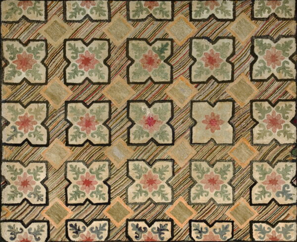 Muted beige, pink, and sage green rug with repeating floral motifs separated by multi-colored diagonal stripes.