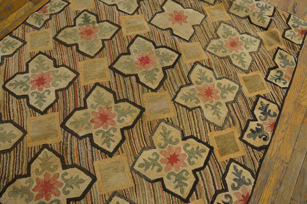 Low-pile rug with colorful vertical stripes and dark-outlined floral medallions on distressed wood floorboards.