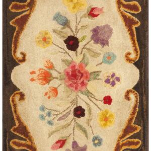 Hooked rug featuring a multicolored floral bouquet surrounded by rust and dark brown scrolling borders.
