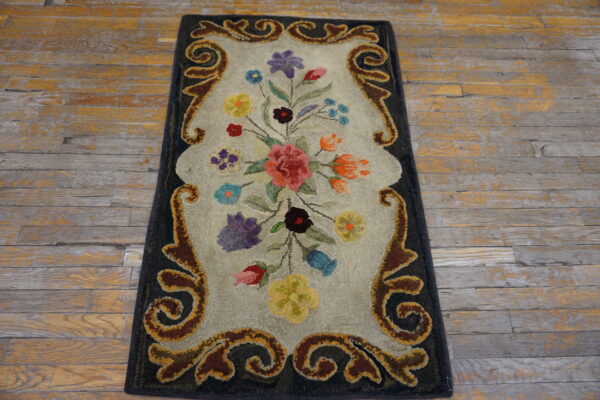 Hooked runner featuring a multicolored floral bouquet and brown scrolled border on rustic wood flooring.