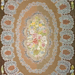 Tan and brown floral rug with a vibrant central bouquet and repeating blue and rust leafy motifs.
