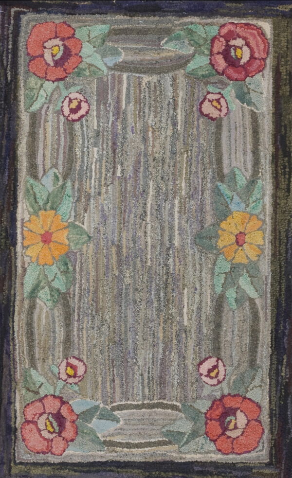 Hooked textile featuring a variegated gray center field framed by colorful rose and yellow flowers.