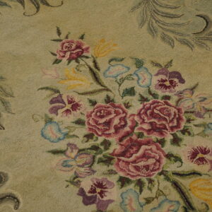 A hooked rug detail shows a central bouquet of pink, purple, and yellow flowers on a pale green ground.