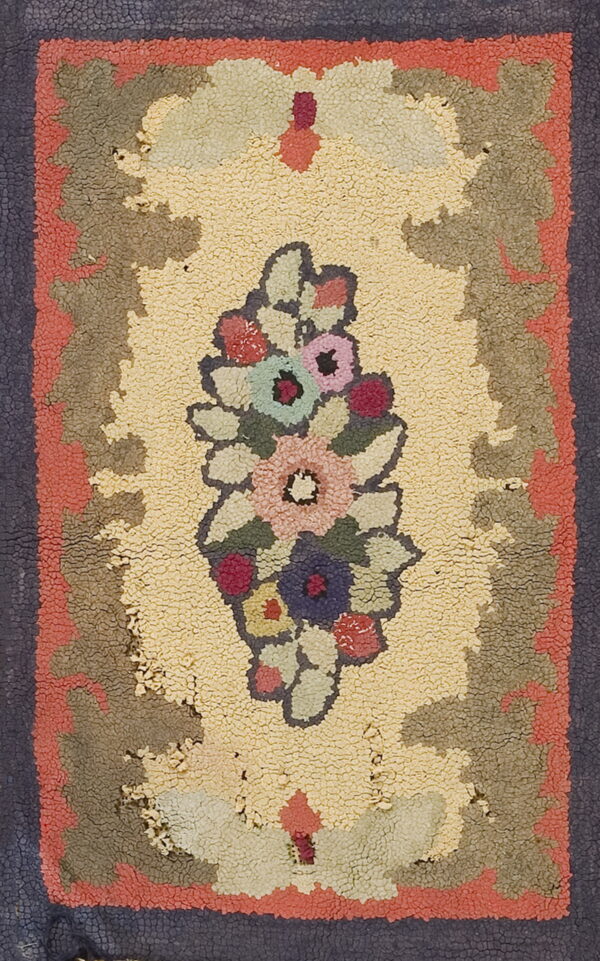Textured hooked rug displaying a central multi-color floral motif on yellow, bordered by coral and dark blue.
