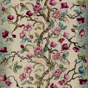 Narrow runner rug with pink flowers and brown branches on a cream field and sage green border.