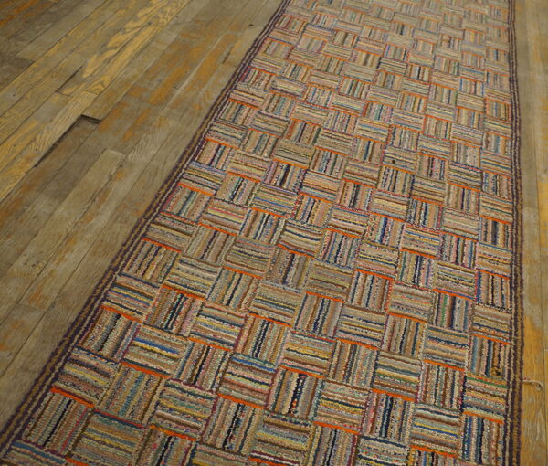 Multicolored textured runner featuring a basketweave pattern of woven stripes on aged wood planks.