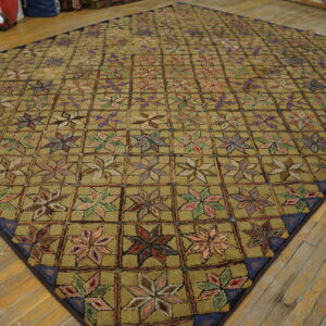 Khaki high-pile rug featuring a repeating grid of colorful, star-like floral motifs rests on wood floors.
