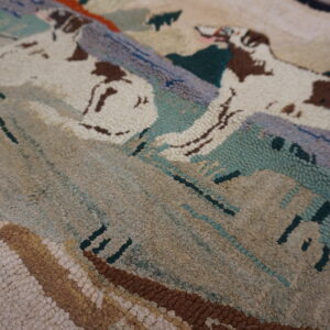 A highly textured, multi-colored rug featuring looped designs of animals and mountains in cream, brown, and sage.