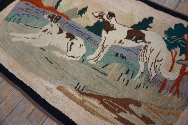 Hooked rug depicting two brown and white dogs in a scene with blue, green, and rust landscapes on wood flooring.