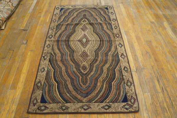Multicolored, high-texture runner rug with wavy concentric diamond patterns on distressed wood flooring.