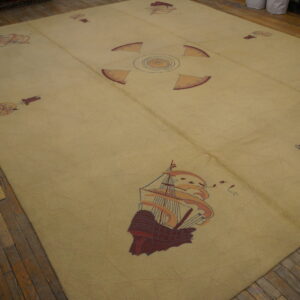 Large light yellow rug featuring nautical ship and compass patterns on distressed wood floors.