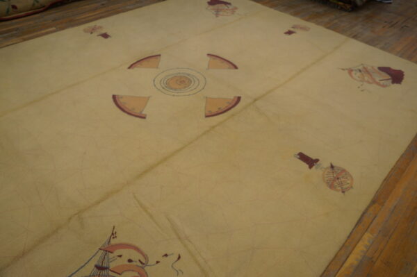 Low-pile beige rug featuring sparse reddish-brown nautical and geometric motifs on wood flooring.