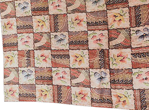Muted patchwork rug with alternating squares of abstract designs and multicolored floral motifs.