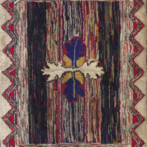 Textured rug featuring a striped dark center with a blue motif, framed by a zigzag border on a beige ground.