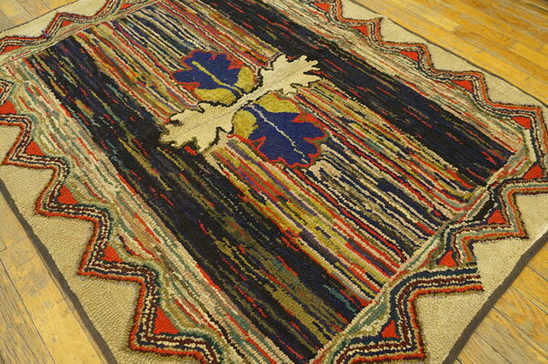 High-texture rug with multicolored stripes and a beige zigzag border resting on light wood floors.