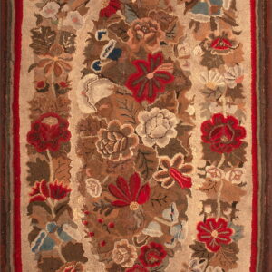 Beige hooked rug featuring a detailed central floral medallion in red, brown, and cream with a striped border.