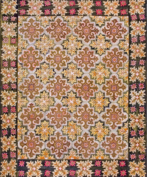 Brown, gold, and olive rug featuring a scrolling quatrefoil pattern and a dark border with pink accents.