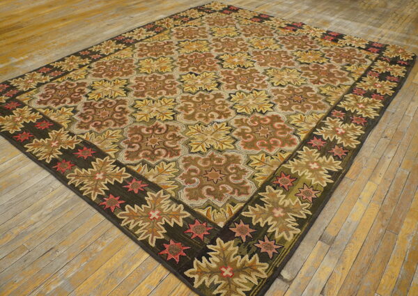 Low pile rug with repeating geometric floral patterns in brown, gold, and deep green on light plank wood floors.