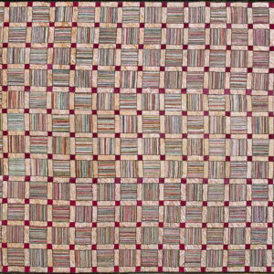 Plush rug featuring a beige grid pattern filled with multicolored striped blocks and dark red intersections.