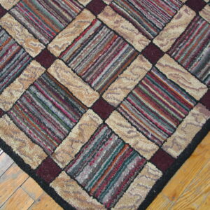 Chunky textured rug features diagonal multicolored striped blocks and solid beige panels on light wood flooring.