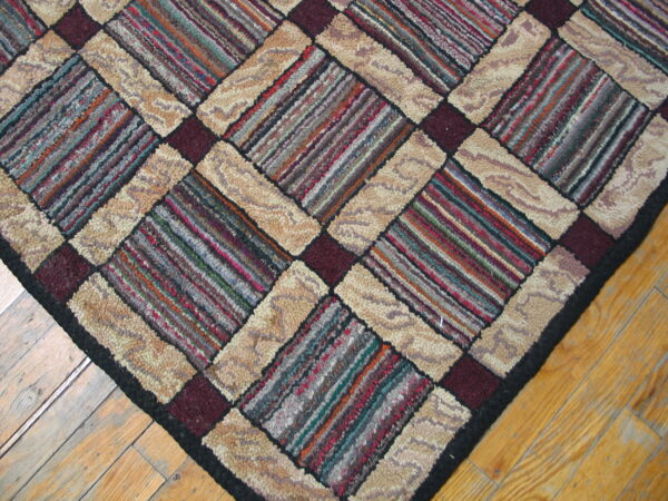 Chunky textured rug features diagonal multicolored striped blocks and solid beige panels on light wood flooring.